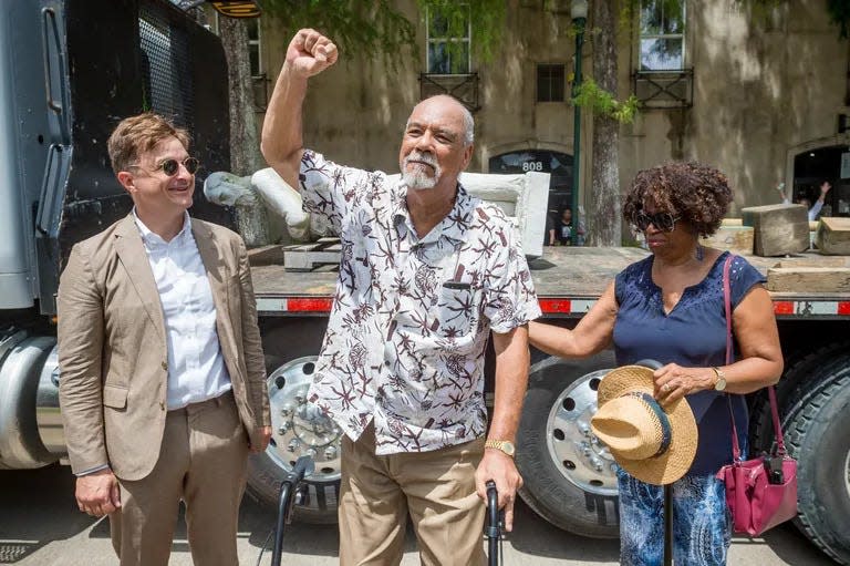 The late Fred Prejean (center) led the effort to take down a Confederate statue in Lafayette. His wife Ola Sims Prejean (right) and Lafayette attorney Jerome Moroux (left) celebrated with him.
