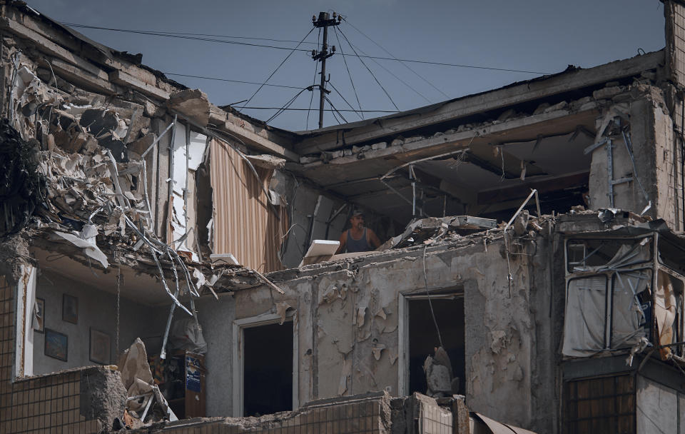 A man cleans an apartment destroyed after Russian shelling in Nikopol, Ukraine, Monday, Aug. 15, 2022. (AP Photo/Kostiantyn Liberov)