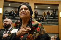 FILE - In this Feb. 27, 2019, file photo, Dolores Huerta, the Mexican-American social activist who formed a farmworkers union with Cesar Chavez, stands for the Pledge of Allegiance in Spanish while visiting the New Mexico Statehouse in Santa Fe, N.M. Immigrant rights activists energized by a new Democratic administration and majorities on Capitol Hill are gearing up for a fresh political battle to push through a proposed bill from President Joe Biden that would open a pathway to citizenship for up to 11 million people. Huerta said the immigration reform push will benefit from the dramatic stories of children being separated from their parents under the Trump administration. (AP Photo/Russell Contreras, File)