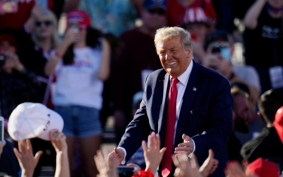 President Donald Trump smiles at supporters at a campaign rally at Phoenix Goodyear Airport - Ross D. Franklin /AP