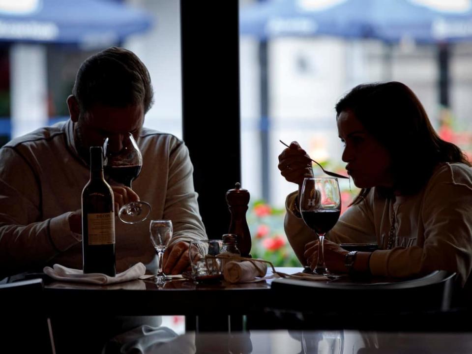 Patrons dine at Hendriks Restaurant and Bar on Yonge Street in Toronto on Oct. 22, 2021. Under current restrictions, food and drink establishments in Ontario are allowed to offer only takeout, drive-thru and delivery services. (Evan Mitsui/CBC - image credit)