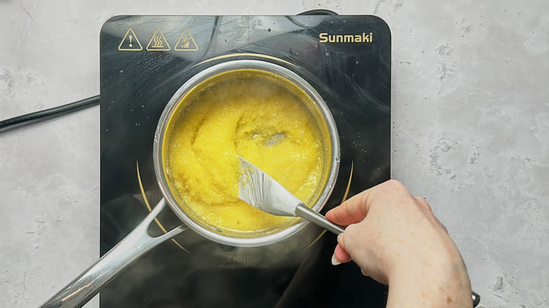 stirring thickened polenta