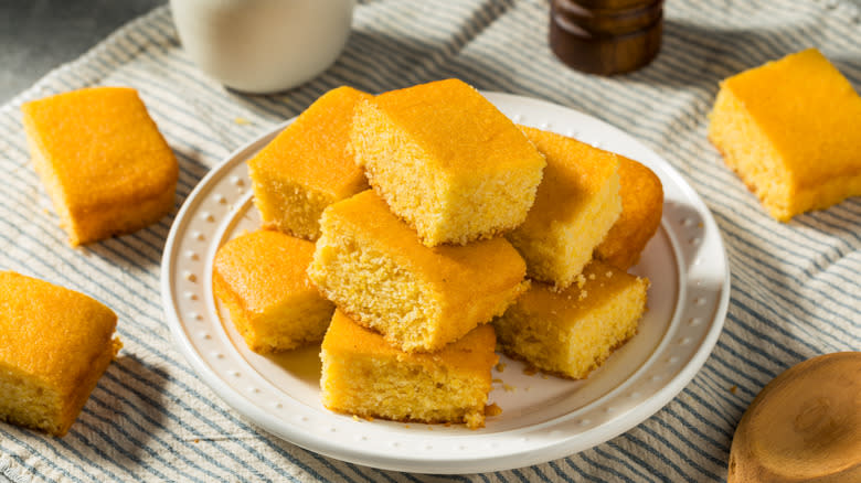 Squares of cornbread on white plate