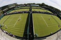 Players practice on the first day's play at the Wimbledon Tennis Championships in London, June 29, 2015. REUTERS/Stefan Wermuth