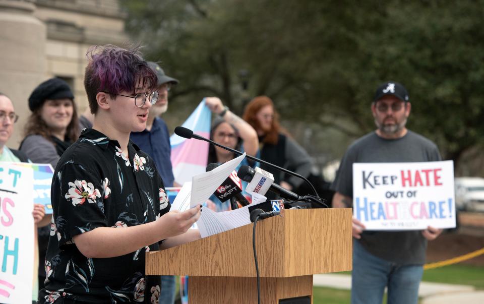 Leviathan Myers-Rowell, 16, of Ocean Springs, Miss., speaks during a rally in support of transgender youth at the state Capitol in Jackson, Miss., Wednesday, Feb. 15, 2022. His father, Thomas Rowell, background right, stands in support of his son and against House Bill 1125. HB 1125 prohibits transgender-related healthcare in Mississippi for people under the age of 18.