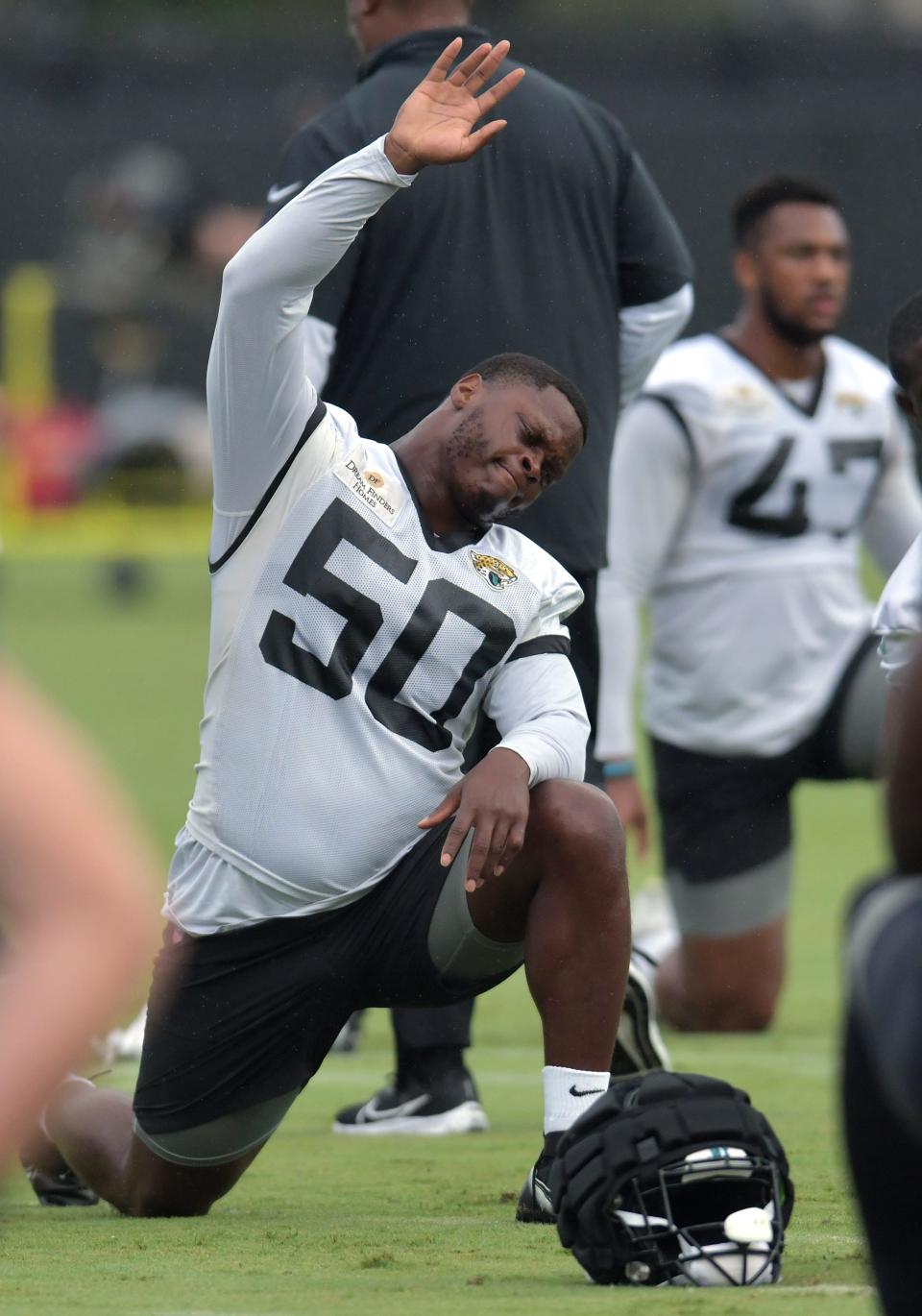 Jacksonville Jaguars linebacker Shaquille Quarterman (50) stretches during warm up drills during the Jacksonville Jaguars Friday morning training camp session July 28, 2023 inside the Miller Electric Center training facility.