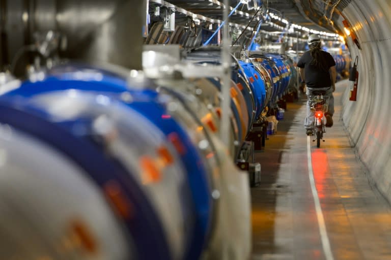 A worker rides his bicycle in a tunnel holding the Large Hadron Collider operated by the European Organisation for Nuclear Research in Meyrin, near Geneva