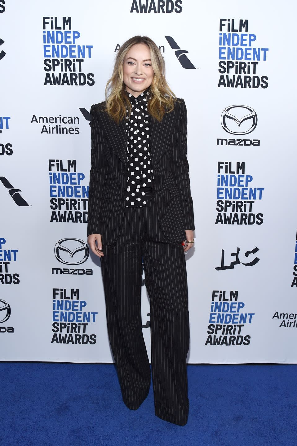 <p>Wilde decided to wear a black pinstripe suit and a black and white polka dot high-neck blouse for the blue carpet at the BOA Steakhouse in West Hollywood. </p>