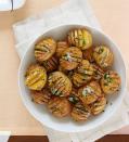 <p>Chive butter is the perfect topping for these tasty little potatoes. They're so good you'll be wanting to recreate this recipe all year long.<br></p><p><em><a href="https://www.womansday.com/food-recipes/food-drinks/recipes/a53986/mini-hasselback-potatoes-with-chive-butter-recipe/" rel="nofollow noopener" target="_blank" data-ylk="slk:Get the Mini Hasselback Potatoes with Chive Butter recipe.;elm:context_link;itc:0;sec:content-canvas" class="link "><strong>Get the Mini Hasselback Potatoes with Chive Butter recipe.</strong></a></em></p>