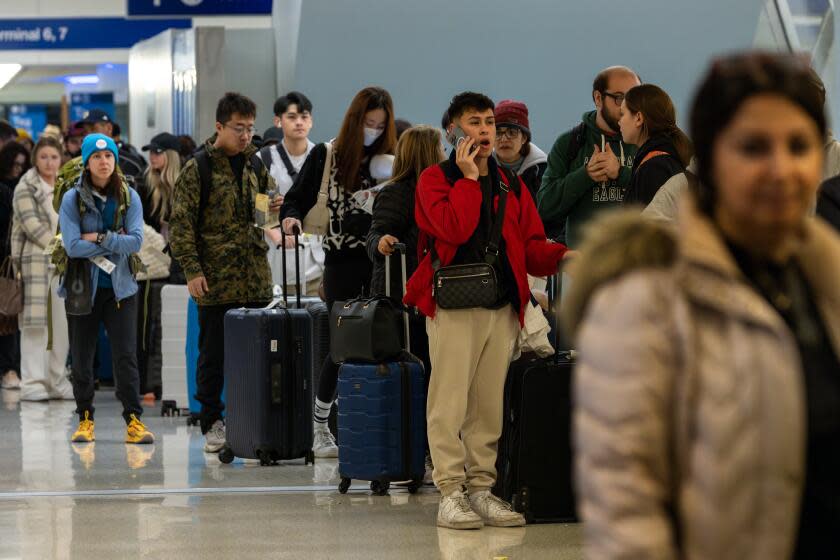 LOS ANGELES, CA - DECEMBER 21: Holiday travelers rush at Los Angeles International Airport on Thursday, Dec. 21, 2023 in Los Angeles, CA. (Irfan Khan / Los Angeles Times)