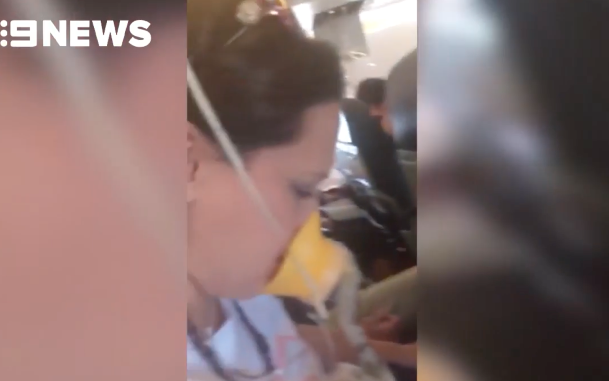 Video shows passengers on the Bali-bound AirAsia flight wearing oxygen masks - Screengrab of 9 News