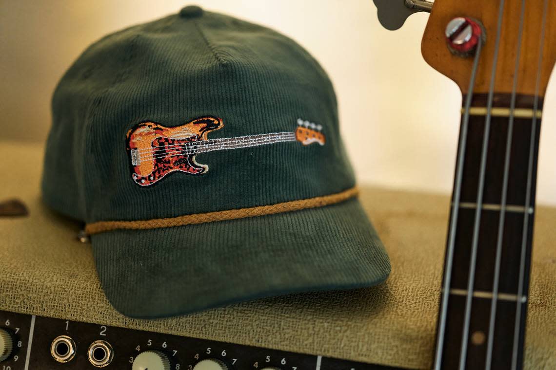 Proceeds from the sale of hats featuring J.T. Cure’s bass guitar “Purdy” will go to Chris and Morgane Stapleton’s Outlaw State of Kind charitable fund, which has helped Eastern Kentucky flood victims, among others. Provided