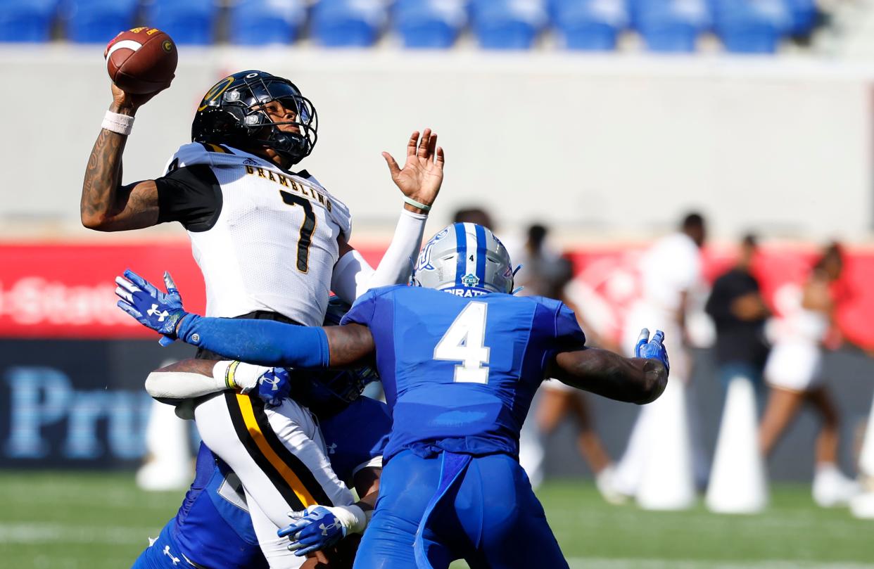 Grambling State quarterback Myles Crawley is tackled by Hampton linebackers Ze'marion Harrell (27) and Qwahsin Townsel (4) during the first half of an NCAA college football game, Saturday, Sept. 2, 2023, in Harrison, N.J. (AP Photo/Noah K. Murray)