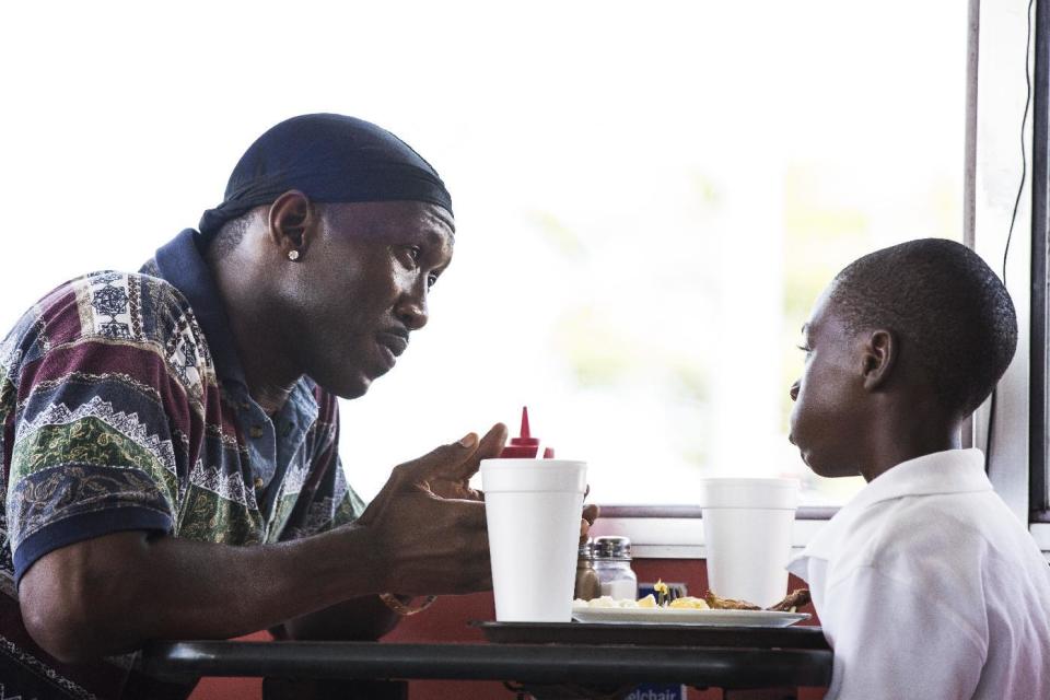 This image released by A24 Films shows Mahershala Ali, left, and Alex Hibbert in a scene from, "Moonlight." Ali is nominated for an Oscar for best supporting actor for his work in "Moonlight." (David Bornfriend/A24 via AP)