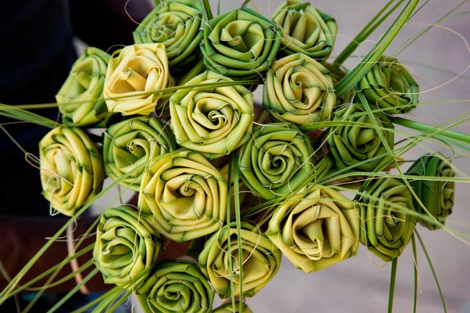 Kareem Nesmith shows palmetto roses he makes and sells in Charleston, South Carolina on Sunday, August 29, 2021. Nesmith says he learned to make the famous craft when he was 7-years-old and sells more than a hundred a day.