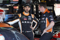 Daniel Suarez, left, talks with a crew member during practice for a NASCAR Cup Series auto race at Michigan International Speedway in Brooklyn, Mich., Saturday, Aug. 10, 2019. (AP Photo/Paul Sancya)