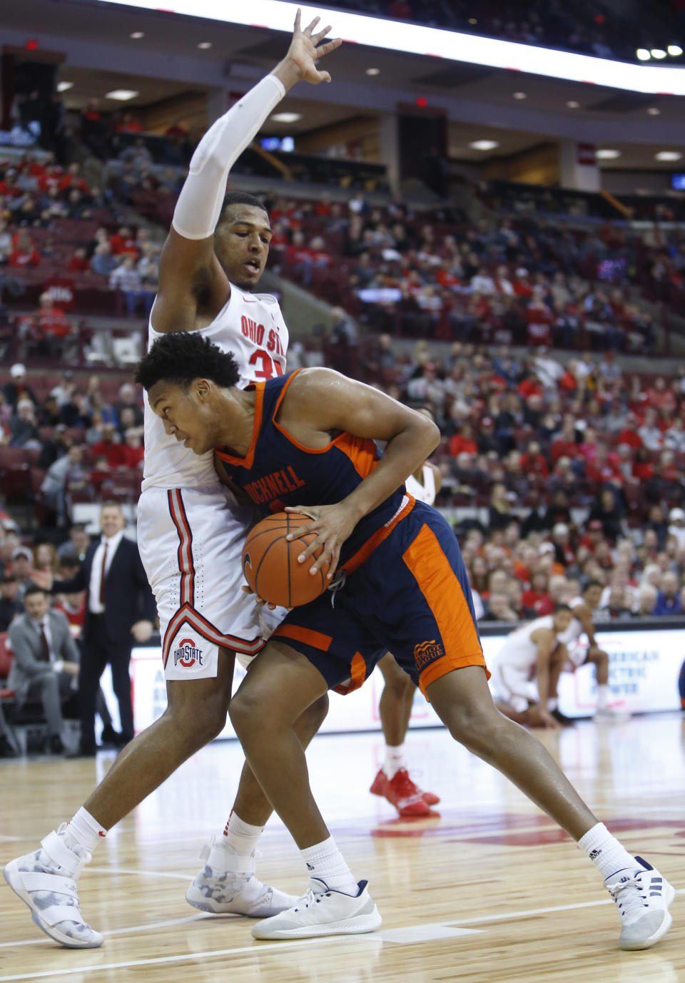 Bucknell's Paul Newman, right, posts up against Ohio State's Kaleb Wesson, left, during the first half of an NCAA college basketball game Saturday, Dec. 15, 2018, in Columbus, Ohio. (AP Photo/Jay LaPrete)