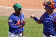 New York Mets starting pitcher Marcus Stroman, left, talks with catcher James McCann during the fifth inning of a spring training baseball game against the Washington Nationals, Thursday, March 18, 2021, in Port St. Lucie, Fla. (AP Photo/Lynne Sladky)