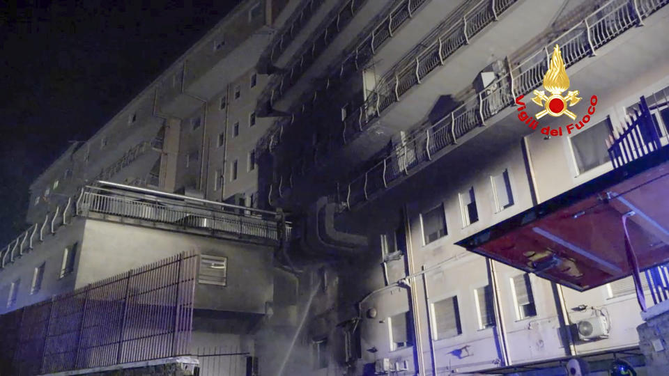 Italian Firefighters spray water on a building of the San Giovanni Evangelista Hospital after a fire broke out causing the death of four people in Tivoli, Italy, Friday, Dec. 8, 2023. (Italian Firefighters Via AP)