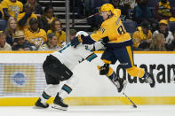 Nashville Predators left wing Tanner Jeannot (84) jumps to get past San Jose Sharks defenseman Jacob Middleton (21) in the second period of an NHL hockey game Tuesday, Oct. 26, 2021, in Nashville, Tenn. (AP Photo/Mark Humphrey)