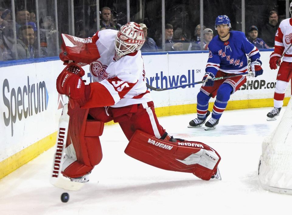Red Wings goalie Alex Nedeljkovic clears the puck away from the Rangers' Ryan Carpenter during the second period on Sunday, Nov.  6, 2022, in New York.