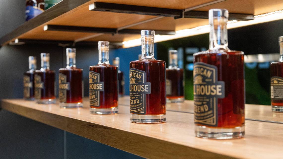 Several Hell House bottles line a shelf within Bespoken Spirits tasting room. Marcus Dorsey/mdorsey@herald-leader.com