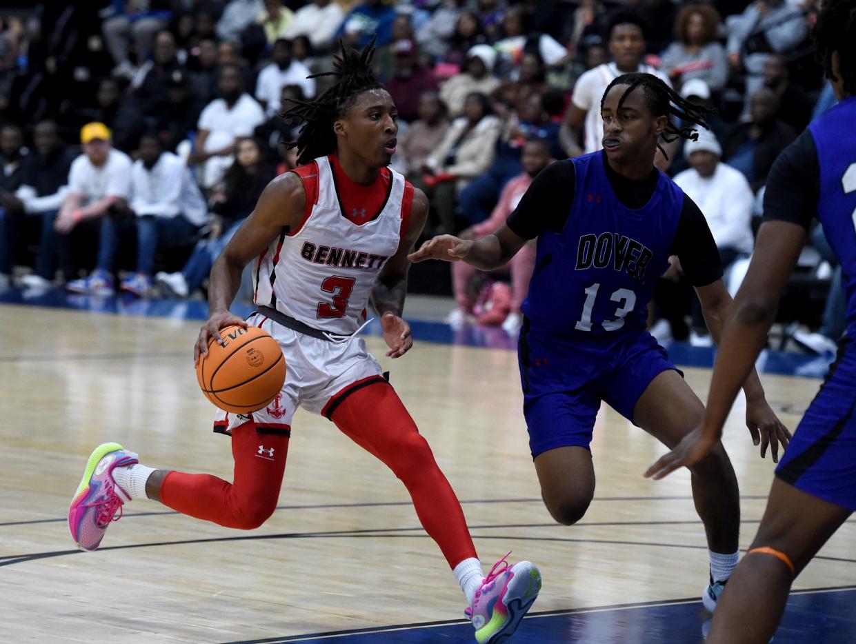 Bennett's Jace Hudson (3) drives to the basket by Dover's Kameron Jackson-Dickson (13) Tuesday, Dec. 26, 2023, at the Wicomico Civic Center in Salisbury, Maryland. Dover defeated Bennett 83-44.