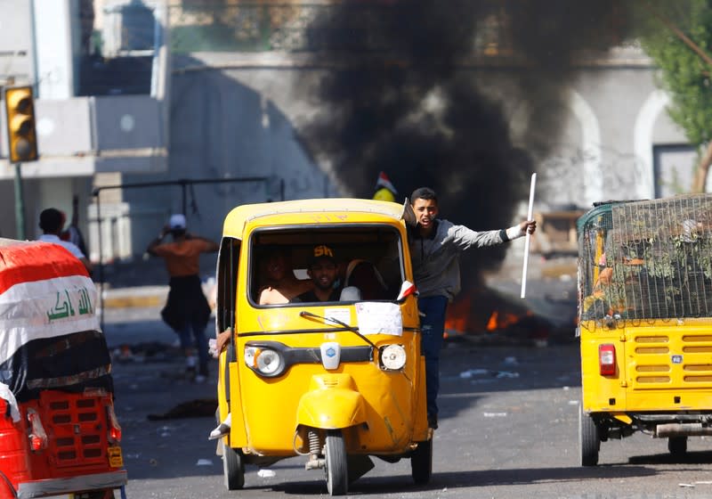 Demonstrators use tuk-tuk during the ongoing anti-government protests in Baghdad