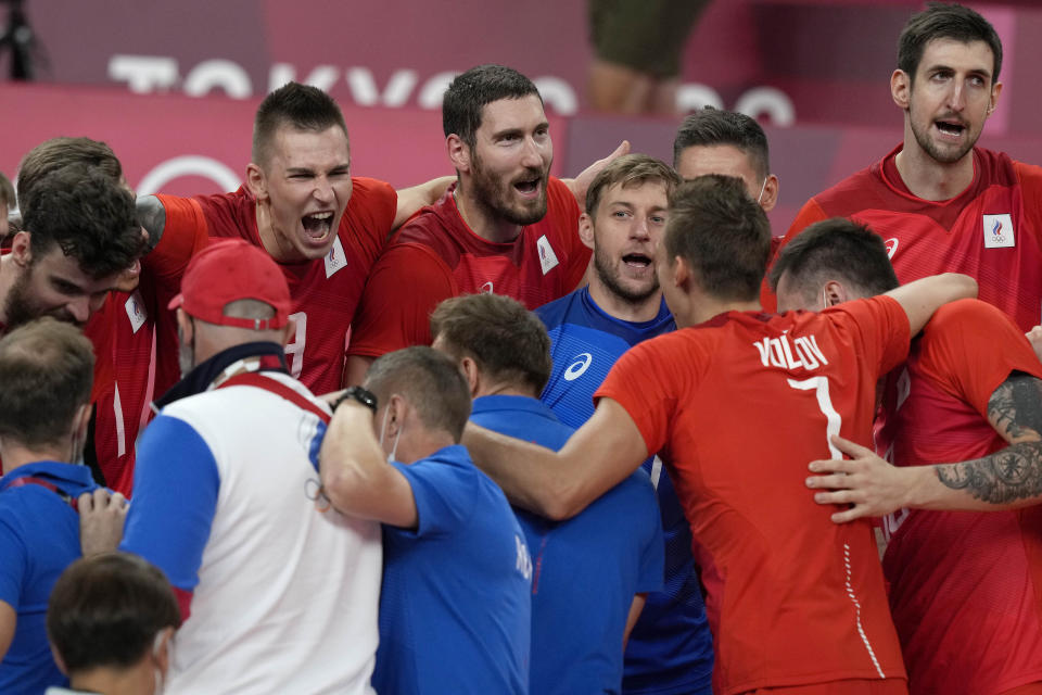 Russian players celebrate winning the men's volleyball quarterfinal match between Canada and Russian Olympic Committee at the 2020 Summer Olympics, Tuesday, Aug. 3, 2021, in Tokyo, Japan. (AP Photo/Frank Augstein)