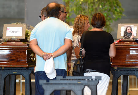 Coffins containing bodies of victims of the Genoa bridge collapse are seen at the Genoa Trade Fair and Exhibition Centre in Genoa, Italy August 17, 2018. REUTERS/Massimo Pinca