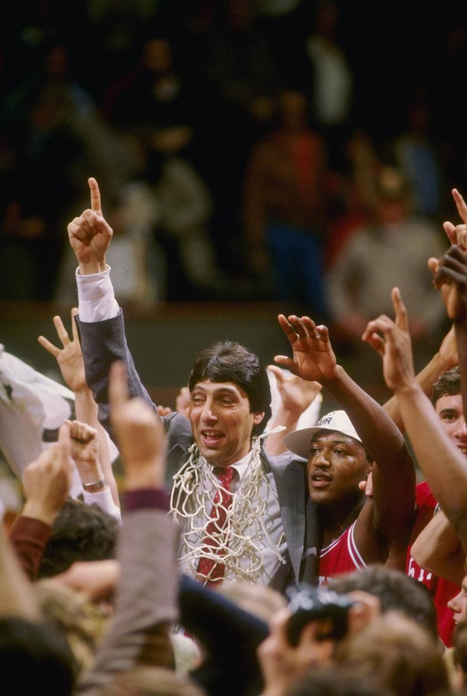 Head coach Jim Valvano of the North Carolina State Wolfpack celebrates with his team after the Wolfpack defeated the Houston Cougars 54-52 in the NCAA men''s basketball championship game at University Arena in Albuquerque, New Mexico.