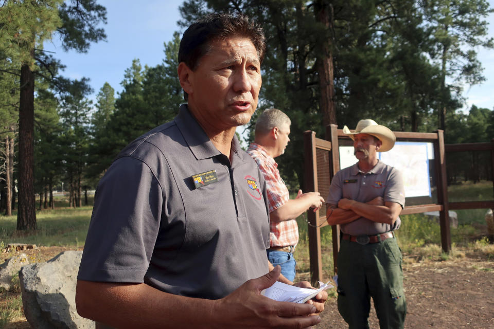 Rich Nieto, incident commander for a wildfire burning near Flagstaff, Ariz., talks about firefighting strategy Tuesday, July 23, 2019. Anxious residents packed up prized possessions as hundreds of firefighters worked to keep a wildfire in a forested Arizona city away from homes and hoped the weather might bring some relief. (AP Photo/Felicia Fonseca)