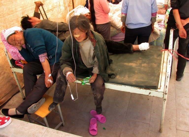 Injured people get treatment in a hospital in Minxian after an eathquake hit northwest Gansu province, on July 22, 2013. The traumatised survivors of two shallow earthquakes that killed at least 94 people in China have begun burying their dead, as they struggled with the devastation left behind