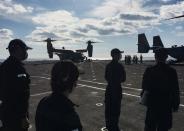 Japan Maritime Self-Defense Force soldiers watch U.S. MV-22 Osprey aircrafts on board of the helicopter destroyer JS Kaga during Keen Sword, at mid-sea off south of Japan