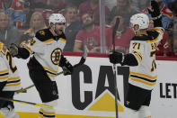 Boston Bruins left wing Jake DeBrusk (74) celebrates a goal with left wing Taylor Hall (71) during the third period of Game 4 of an NHL hockey Stanley Cup first-round playoff series against the Florida Panthers, Sunday, April 23, 2023, in Sunrise, Fla. The Bruins defeated the Panthers 6-2. (AP Photo/Marta Lavandier)