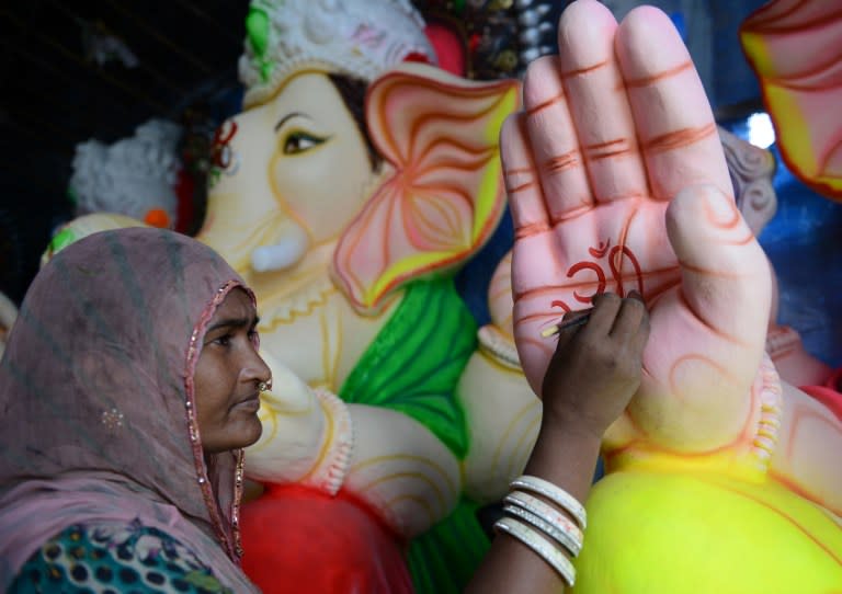 <p>An Indian artist gives the final touches to a statue of the Hindu god Lord Ganesh ahead of the forthcoming Ganesh Chaturthi festival at a workshop in Hyderabad on August 29, 2016. The statues are being prepared for the Ganesh Chaturthi festival a popular eleven-day long Hindu religious festival in India which will be celebrated from September 5 to 15. </p>