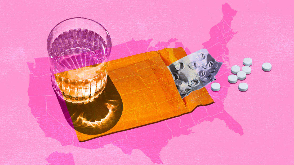 Abortion pills in an envelope next to a glass of water on a pink U.S. map