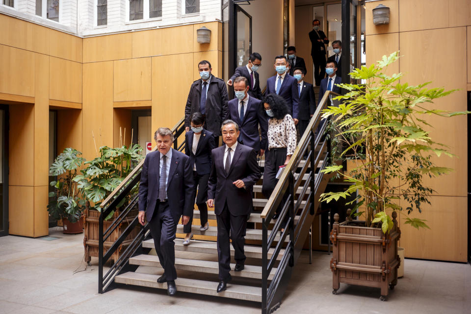 Chinese Foreign Minister Wang Yi, right, and French Institute for International Relations director Thierry de Montbrial arrives for a press conference in Paris, Sunday, Aug. 30, 2020. Chinese Foreign Minister Wang Yi is in France as part of a five-country trip to Europe, his first since the coronavirus pandemic. (AP Photo/Kamil Zihnioglu)