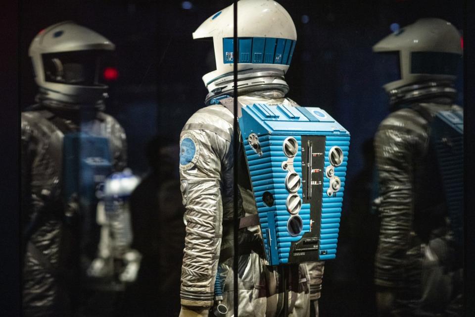 A space suit in a glass case in a museum