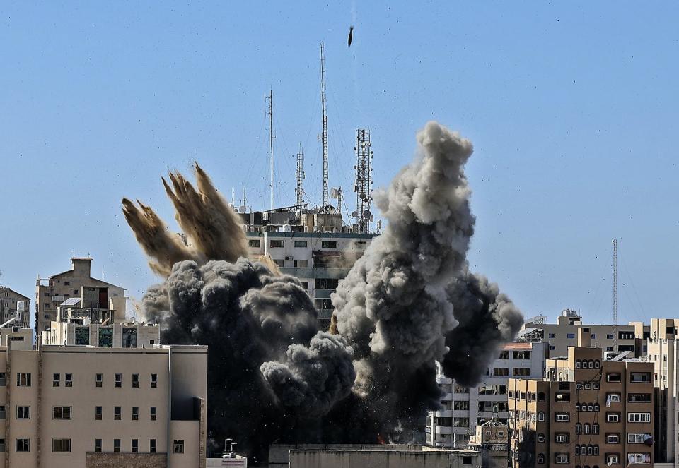 A bomb hits the building housing international media, including The Associated Press, in Gaza City, May 15, 2021. Mahmud Hams /Pool Photo via AP