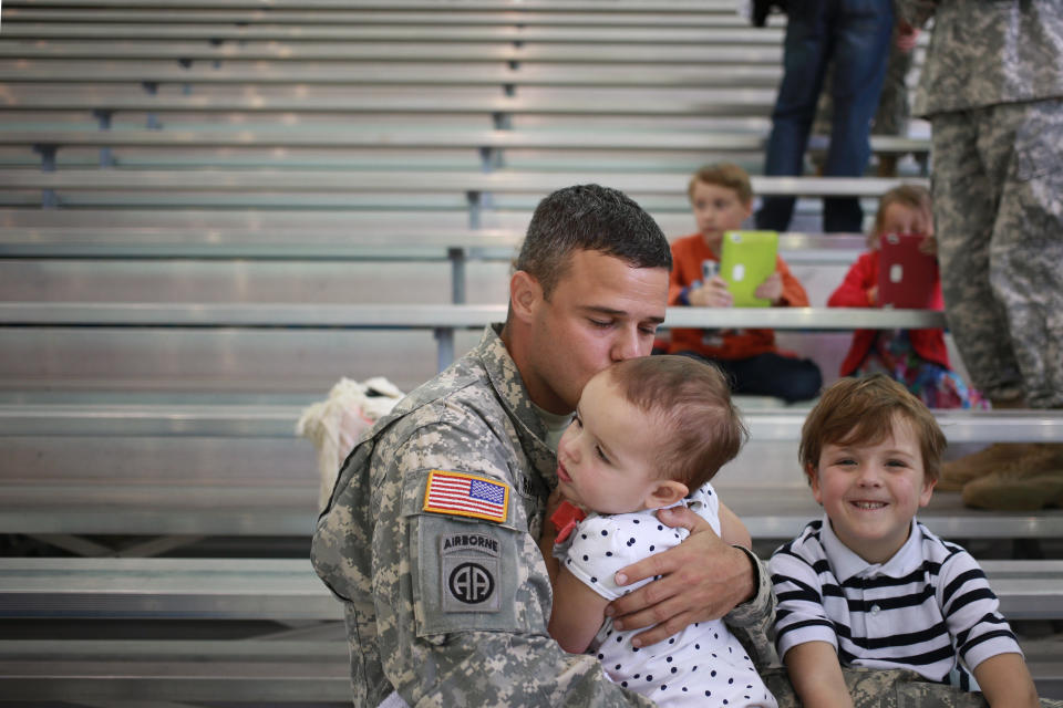 Maj. Dave Armeson of the U.S. Army's 101st Airborne Division kisses his daughter Adelyn Armeson, 2, during a homecoming ceremony at Campbell Army Airfield on March 21, 2015, in Fort Campbell, Kentucky.&nbsp;