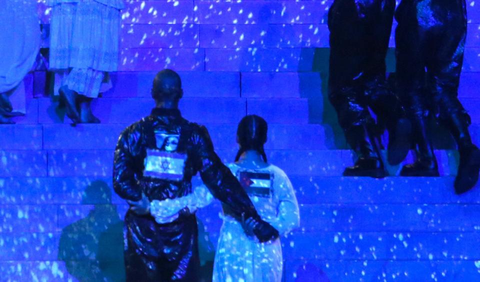 This handout photo released by KAN shows two of Madonna's dancers (foreground) side-by-side with Israeli and Palestinian flags on their backs during her performance in an apparent call for unity.

Madonna and US rapper Quavo performed during a guest appearance at the 64th edition of the Eurovision Song Contest 2019 at Expo Tel Aviv on May 19, 2019, in the Israeli coastal city of Tel Aviv.