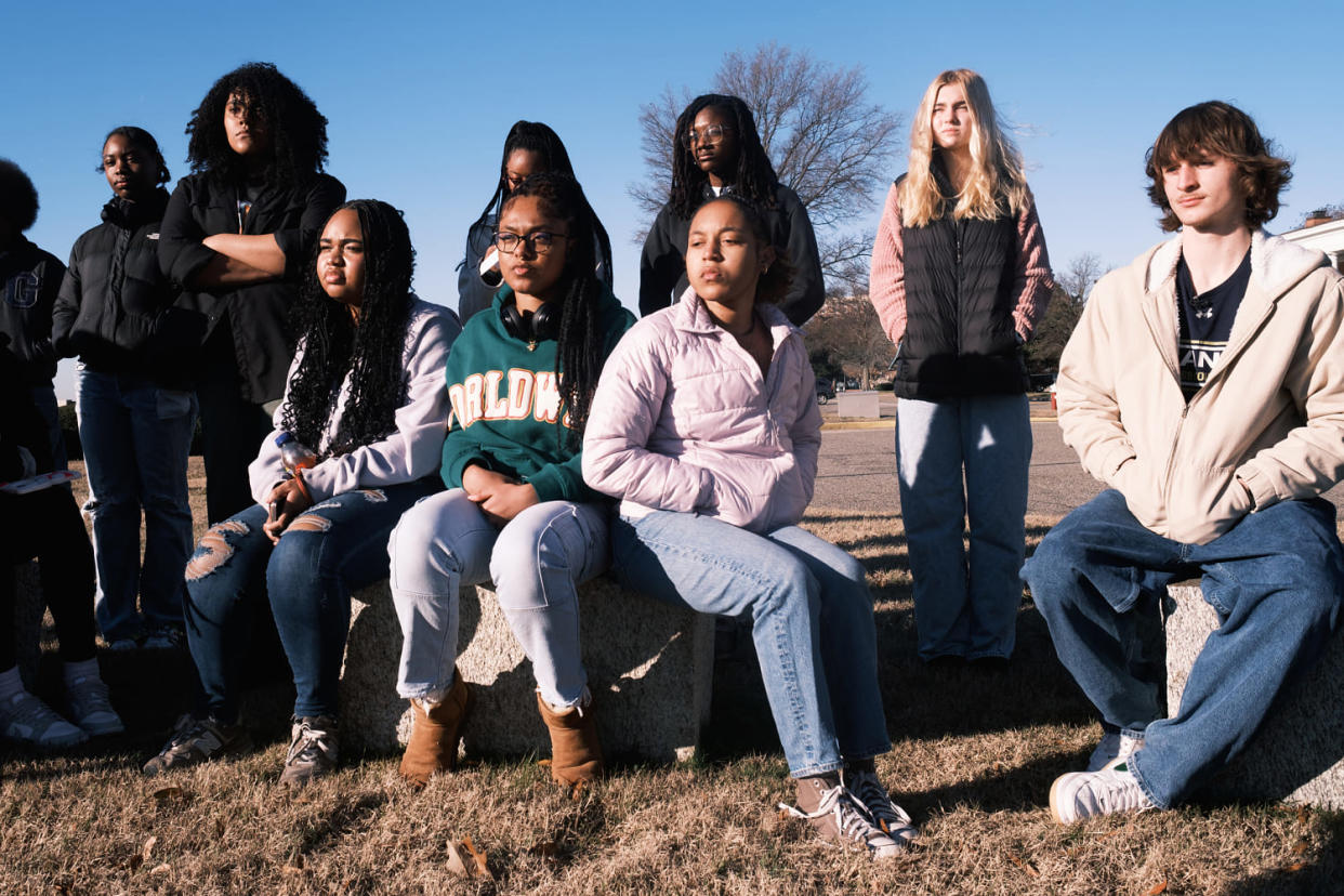Students sit at the grounds of Old Point Comfort at Fort Monroe in Hampton, Va., on Jan. 11 as they listen to a tour guide brief them on the history of the land and engage them with exercises. (Kyna Uwaeme for NBC News)
