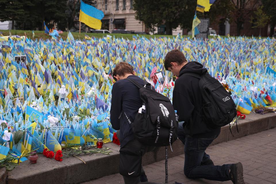 Ukrainians react during the All-National minute of silence in commemoration of Ukrainian soldiers killed in the country's war against Russia on Independence square in Kyiv on Oct. 1, 2023.