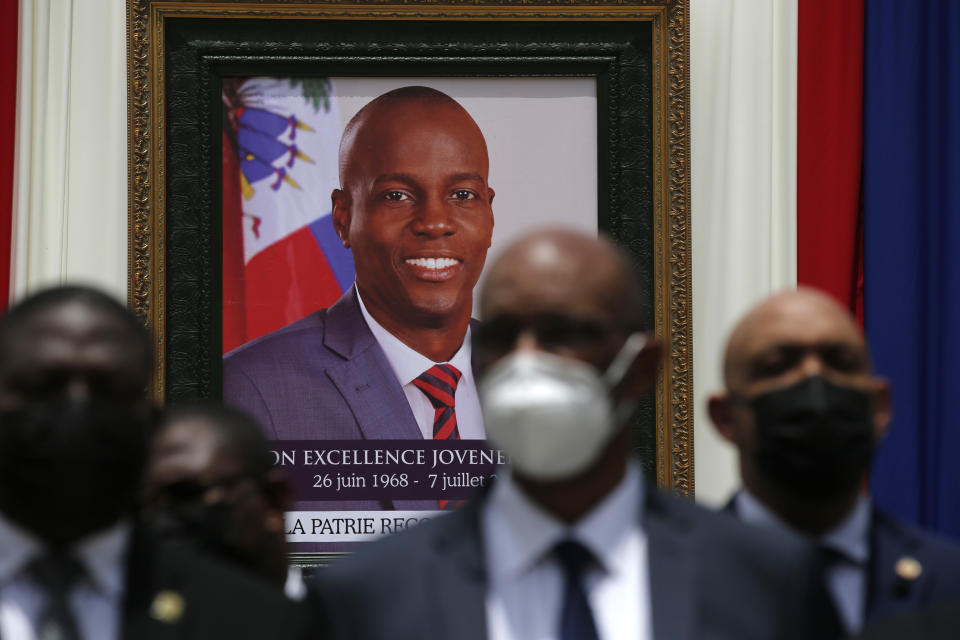 FILE - Authorities pose for a group photo in front of the portrait of late Haitian President Jovenel Moise at at the National Pantheon Museum during his memorial service in Port-au-Prince, Haiti. Moise was assassinated on July 7 at his home. Less than a dozen elected officials are currently representing a country of more than 11 million people. (AP Photo/Joseph Odelyn, File)