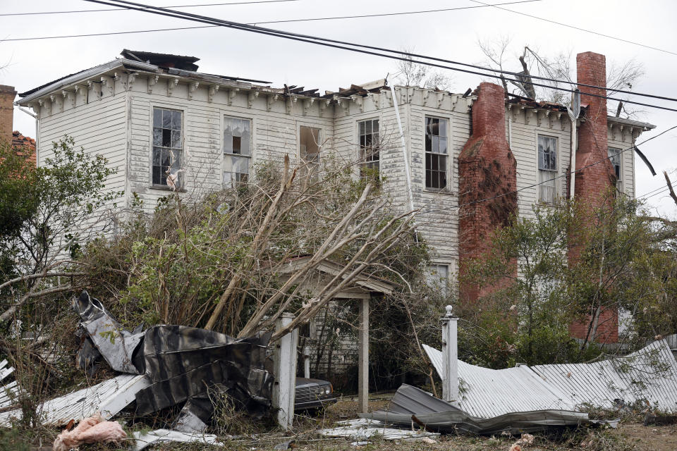 A damaged house is surrounded by debris in Selma, Ala., Friday, Jan. 13, 2023, after a tornado passed through the area. Rescuers raced Friday to find survivors in the aftermath of a tornado-spawning storm system that barreled across parts of Georgia and Alabama. (AP Photo/Stew Milne)