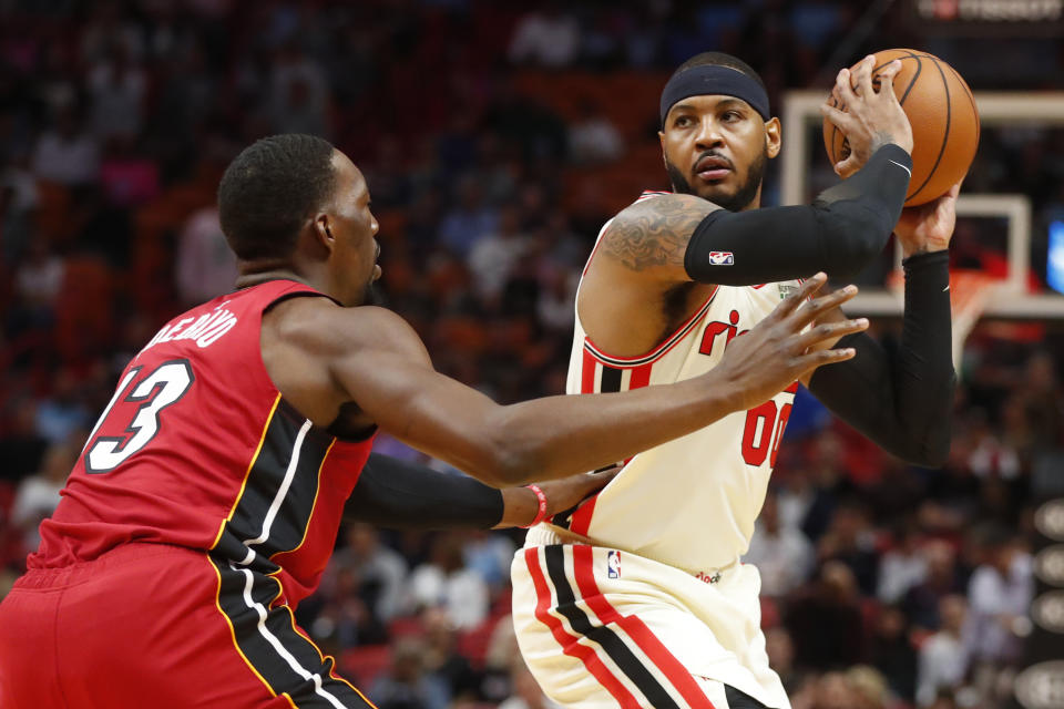Portland Trail Blazers forward Carmelo Anthony (00) looks for an opening past Miami Heat center Bam Adebayo (13) during the first half of an NBA basketball game, Sunday, Jan. 5, 2020, in Miami. (AP Photo/Wilfredo Lee)