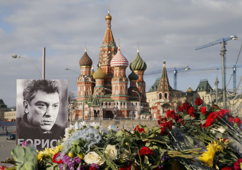 A portrait of Kremlin critic Boris Nemtsov and flowers are pictured at the site where he was killed on February 27, with St. Basil's Cathedral seen in the background, at the Great Moskvoretsky Bridge in central Moscow March 6, 2015.  REUTERS/Maxim Shemetov 