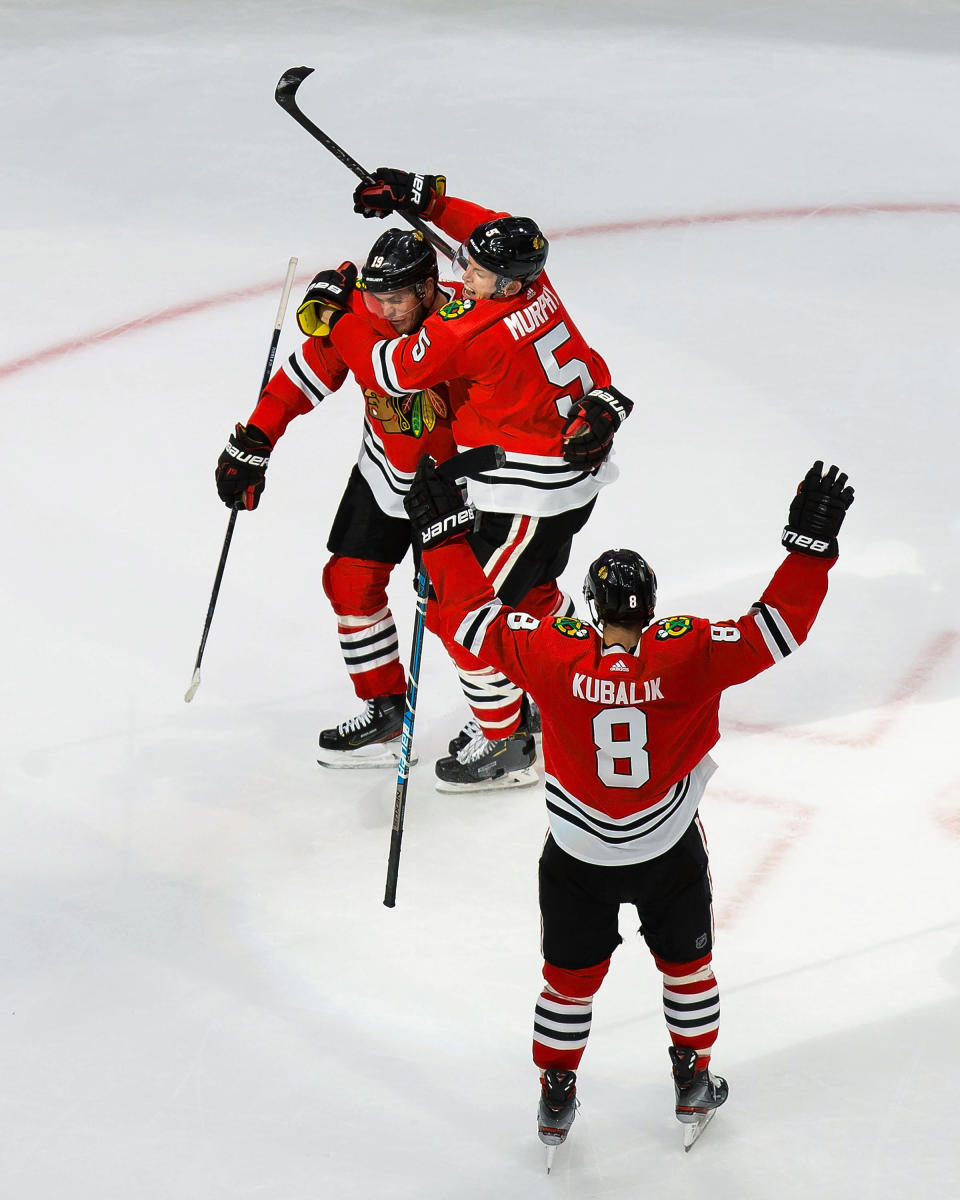 Chicago Blackhawks' Jonathan Toews (19), Connor Murphy (5) and Dominik Kubalik (8) celebrate a goal against the Edmonton Oilers during the third period of an NHL hockey playoff game Wednesday, Aug. 5, 2020, in Edmonton, Alberta. (Codie McLachlan/The Canadian Press via AP)