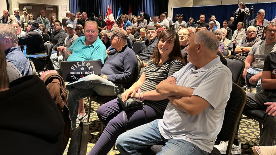 Over 200 people attended the rally, many of them picking up free signs that said "protect hunters" or "axe the tax" before sitting down.